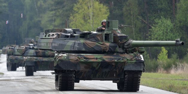French tank soldiers arrive with their tanks type 'Leclerc' prior the friendship shooting of several nations during the exercise 'Strong Europe Tank Challenge 2017' at the exercise area in Grafenwoehr, near Eschenbach, southern Germany, on May 12, 2017.Platoons from NATO nations France, Germany, USA and their partners Austria and Ukraine take part in this exercise. / AFP PHOTO / Christof STACHE (Photo credit should read CHRISTOF STACHE/AFP/Getty Images)