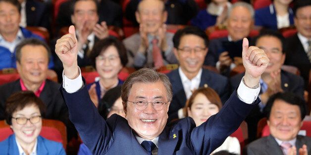 SEOUL, SOUTH KOREA - MAY 09: South Korean presidential candidate Moon Jae-in of the Democratic Party of Korea reacts after a television report on an exit poll of the new president at the party's auditorium in the National assembly on May 9, 2017 in Seoul, South Korea. Polls have opened in South Korea's presidential election, called seven months early after former President Park Geun-hye was impeached for her involvement in a corruption scandal. (Photo by Chung Sung-Jun/Getty Images)