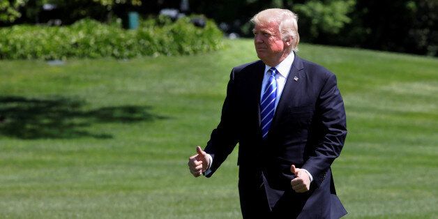 U.S. President Donald Trump gestures as he walks on the South Lawn of the White House upon his return to Washington, U.S., May 17, 2017. REUTERS/Yuri Gripas