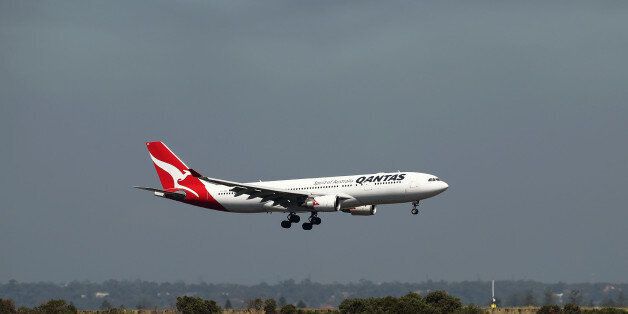 An Airbus SE A330-300 aircraft operated by Qantas Airways Ltd. lands at Sydney Airport in Sydney, Australia, on Thursday, Feb. 23, 2017. Qantas' first-half earnings dropped 7.5 percent, less than the company expected, as overseas competitors rolled out more routes and international air fares fell. Photographer: Brendon Thorne/Bloomberg via Getty Images