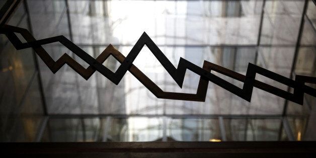 An index curve design sits on a glass panel in the reception area of the Hellenic Exchanges - Athens Stock Exchange SA in Athens, Greece, on Wednesday, Feb. 1, 2017. Greek assets have been roiled since Thursday after a meeting between Finance Minister Euclid Tsakalotos and the nations bailout auditors ended in disagreement last week. Photographer: Yorgos Karahalis/Bloomberg via Getty Images