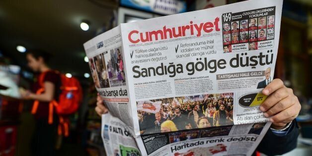 A man reads Cumhuriyet daily newspaper bearing a headline which translates as 'Shadow on ballot box'' in Istanbul on April 17, 2017, a day after Turkey's referendum.The deputy leader of Turkey's opposition Republican People's Party (CHP) called on April 17, 2017 for the results of a referendum agreeing new powers for President Recep Tayyip Erdogan to be annulled. / AFP PHOTO / YASIN AKGUL (Photo credit should read YASIN AKGUL/AFP/Getty Images)