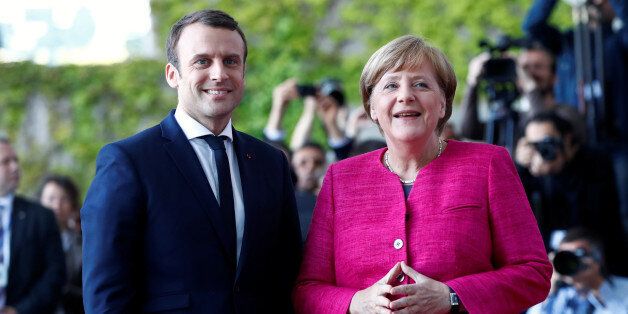 German Chancellor Angela Merkel and French President Emmanuel Macron arrive at a ceremony at the Chancellery in Berlin, Germany, May 15, 2017. REUTERS/Fabrizio Bensch