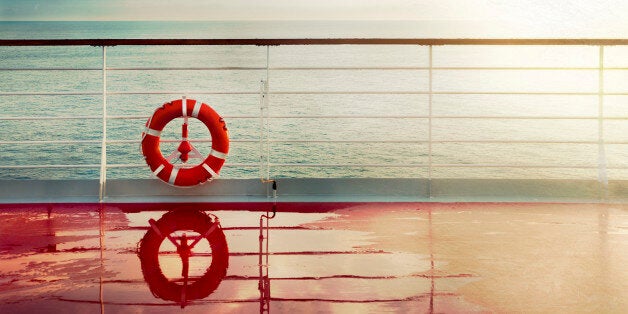 Grunge cruise deck background at dawn.Lifebuoy hand railing deck. Vintage look.