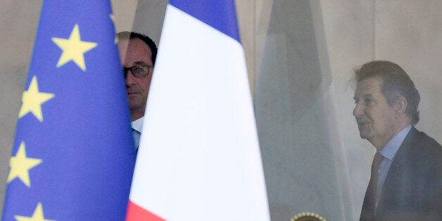 French President Francois Hollande (L) is seen between a French national flag and an European flag, next to French President's Chief of Staff, Jean-Pierre Jouyet (R), as he leaves his last weekly cabinet meeting at the Elysee presidential Palace, in Paris, on May 10, 2017, four days before the formal handover of power from outgoing head of state Francois Hollande. / AFP PHOTO / STEPHANE DE SAKUTIN (Photo credit should read STEPHANE DE SAKUTIN/AFP/Getty Images)