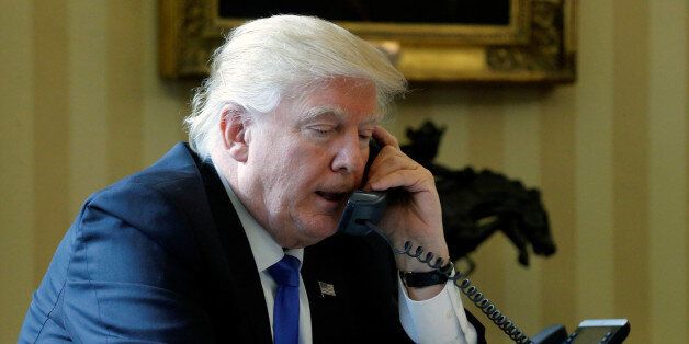 U.S. President Donald Trump speaks by phone with Russia's President Vladimir Putin in the Oval Office at the White House in Washington, U.S. January 28, 2017. REUTERS/Jonathan Ernst