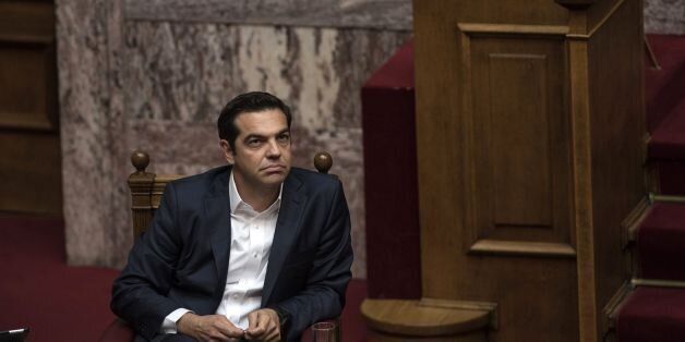 Greek Prime Minister Alexis Tsipras listens during a parliamentary session in Athens on May 18, 2017. Greece's parliament was to approve a new round of austerity cuts, hoping to secure a pledge of debt relief and loan disbursements by the country's EU-IMF creditors this month. / AFP PHOTO / Angelos Tzortzinis (Photo credit should read ANGELOS TZORTZINIS/AFP/Getty Images)