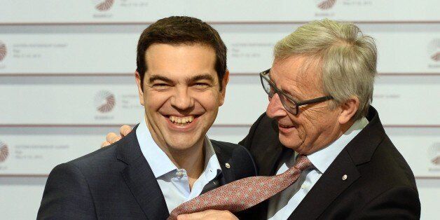 Greek Prime Minister Alexis Tsipras (L) and President of the European Commission Jean-Claude Juncker joke about a tie on the second day of the fourth European Union (EU) eastern Partnership Summit in Riga, on May 22, 2015 as Latvia holds the rotating presidency of the EU Council. EU leaders and their counterparts from Ukraine and five ex-Soviet states hold a summit focused on bolstering their ties, an initiative that has been undermined by Russia's intervention in Ukraine. AFP PHOTO / JANEK SKARZYNSKI (Photo credit should read JANEK SKARZYNSKI/AFP/Getty Images)