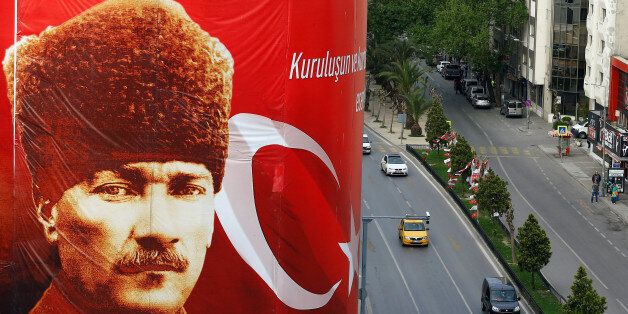 A poster carrying a picture of modern Turkey's founder Mustafa Kemal Ataturk is seen on a construction site ahead of the constitutional referendum in the Aegean port city of Izmir, Turkey, April 15, 2017. REUTERS/Osman Orsal