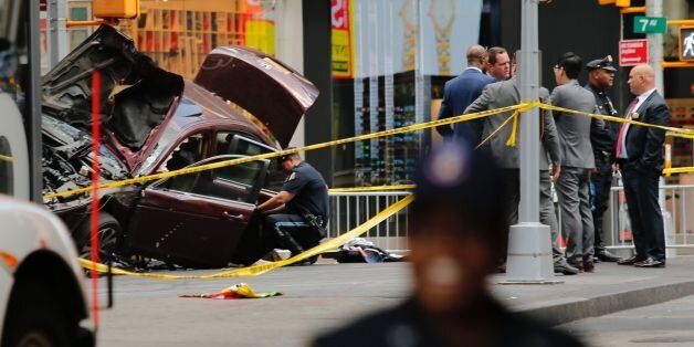 Police officers secure the area near a car after it plunged into pedestrians in Times Square in New York on May 18, 2017.The man who drove a car into a crowd in Times Square on Thursday, killing one person and injuring 22 others, served in the US Navy and has a criminal record, New York's mayor said, adding authorities did not believe it was a terror attack. / AFP PHOTO / EDUARDO MUNOZ ALVAREZ (Photo credit should read EDUARDO MUNOZ ALVAREZ/AFP/Getty Images)