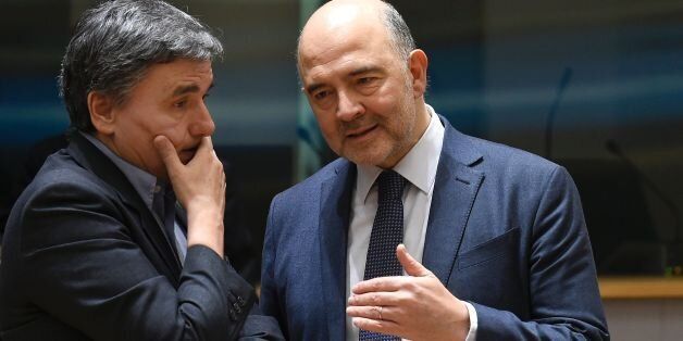 Greek Finance Minister Euclid Tsakalotos (L) talks with EU Commissioner of Economic an d Financial Affairs, Taxation and Customs Pierre Moscovici (R) during an Eurogroup meeting at the EU headquarters in Brussels on February 20, 2017. / AFP / JOHN THYS (Photo credit should read JOHN THYS/AFP/Getty Images)