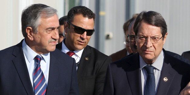 U.N. member of the Committee on Missing Persons (CMP) Paul Henri Arni (R) talks with Greek Cypriot leader and Cyprus President Nicos Anastasiades (C) and Turkish Cypriot leader Mustafa Akinci outside the CMP Anthropological Laboratory in the buffer zone of Nicosia airport December 20, 2015. REUTERS/Yiannis Kourtoglou