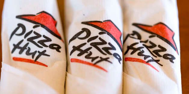 TORONTO, ONTARIO, CANADA - 2016/05/08: Pizza Hut rolled up paper napkin with logo printed on them while resting on wooden table. (Photo by Roberto Machado Noa/LightRocket via Getty Images)