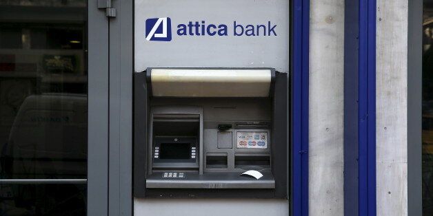 A transaction receipt is seen on an ATM outside a closed Attica Bank branch in Athens, Greece June 30, 2015. The head of the European Commission made a last-minute offer to try to persuade Greek Prime Minister Alexis Tsipras to accept a bailout deal he has rejected before a referendum on Sunday which EU partners say will be a choice of whether to stay in the euro. REUTERS/Alkis Konstantinidis