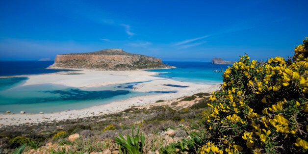 One of the most visited beaches in Greece, Balos. It is located in the western part of the island in the perfecture of Chania and is about one hour driving from Chania. Balos is the most iconic beach in Crete and attracts thousands of tourists every day as it seems like an exotic beach. The place is protected. There are shallow and warm waters, sand dunes in the sandy beach and the water is crystal clear with turqoise color. There is also the pirate island called Gramvousa. People can go to Balo