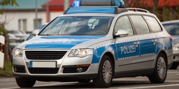 german police patrol car with flashing blue lights on the street