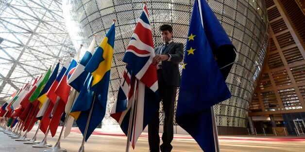 An organiser adjusts the British national flag on April 29, 2017, prior to the EU leaders summit at the Europa building, the main headquarters of European Council and the Council of the EU, in Brussels.The 27 ?EU leaders hold a summit to adopt Brexit negotiating guidelines. / AFP PHOTO / JOHN THYS (Photo credit should read JOHN THYS/AFP/Getty Images)