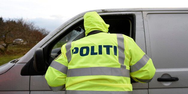 A Danish policeman checks a vehicle at a checkpoint on the German-Danish border crossing in Froslev, January 4, 2016. REUTERS/Fabian Bimmer