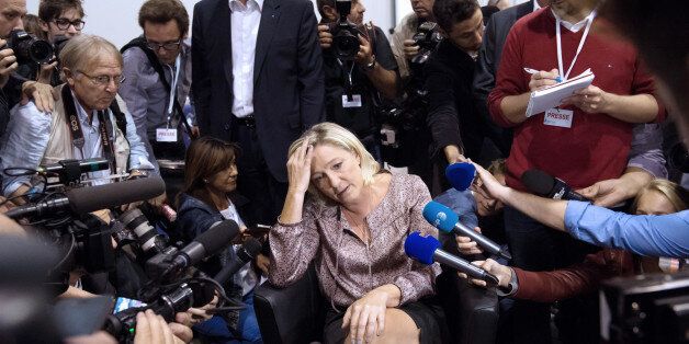 French far-right Front National (FN) party president Marine Le Pen (C) talks to journalists as she attends the FN summer congress on September 14, 2013 in Marseille, southern France. AFP PHOTO / BERTRAND LANGLOIS (Photo credit should read BERTRAND LANGLOIS/AFP/Getty Images)