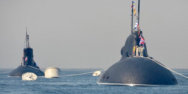 Russian submarines sail during a rehearsal for the Navy Day parade in the far eastern port of Vladivostok, Russia, July 30, 2016. REUTERS/Yuri Maltsev
