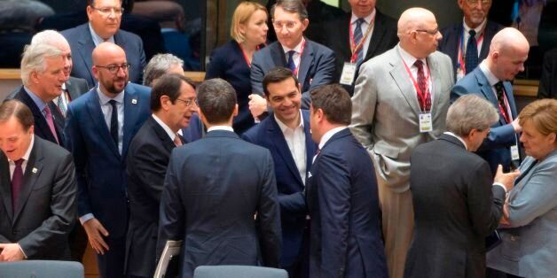Greek Prime Minister Alexis Tsipras (C) speaks with Luxembourg's Prime Minister Xavier Bettel (3rd R) and Cypriot President Nicos Anastasiades (3rd L) among other among other EU leaders during a special EU leaders' meeting at the Europa building, the main headquarters of European Council and the Council of the EU, in Brussels, on April 29, 2017.The 27 ?EU leaders hold a summit to adopt Brexit negotiating guidelines. EU President Donald Tusk urged the bloc to keep a united front at a special Brexit summit in Brussels, saying it will also help Britain if they can reach a deal. / AFP PHOTO / POOL / Virginia Mayo (Photo credit should read VIRGINIA MAYO/AFP/Getty Images)