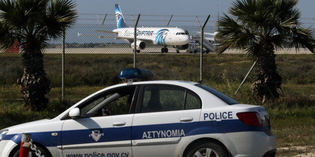 Police stand guard at Larnaca Airport near a hijacked EgyptAir Airbus A320 , March 29, 2016. REUTERS/Yiannis Kourtoglou