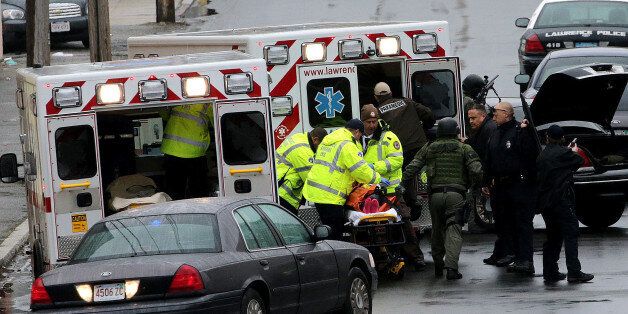LAWRENCE, MA - APRIL 26: A critically injured woman is placed inside an ambulance during a domestic shooting and standoff at 16-18 Melrose St., in Lawrence, Mass., on April 26, 2016. (Photo by Barry Chin/The Boston Globe via Getty Images)