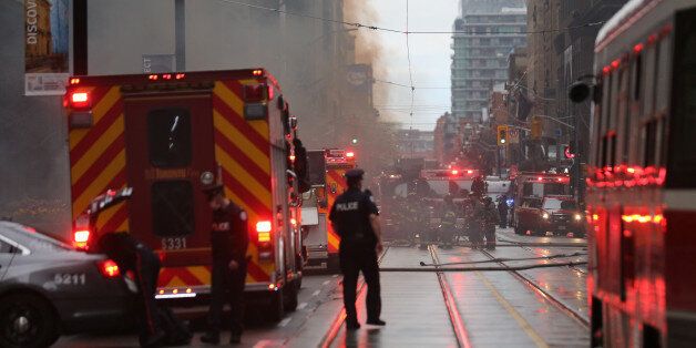 Police and emergency crews at the scene of a fire investigation of an underground explosion in the financial district in downtown Toronto, Ontario, Canada May 1, 2017. REUTERS/Chris Helgren
