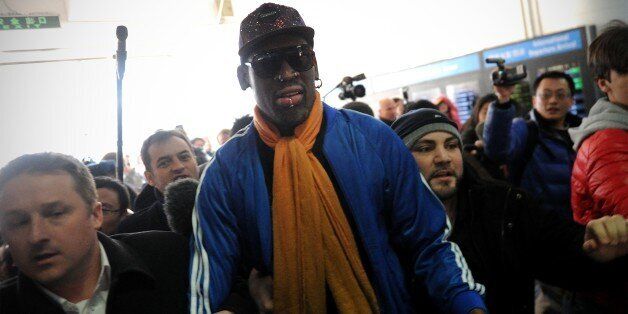 Former US basketball player Dennis Rodman (C) arrives at Beijing International Airport from North Korea on January 13, 2014. Rodman returned to China from Pyongyang after a seven-day trip where he sang 'Happy birthday to you!' to North Korean leader Kim Jong-Un on January 8. AFP PHOTO / WANG ZHAO (Photo credit should read WANG ZHAO/AFP/Getty Images)