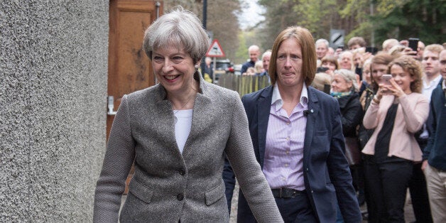 Britain's Prime Minister Theresa May (C) goes door-to-door campaigning for Andrew Bowie, Conservative candidate for West Aberdeenshire and Kincardine in the village of Banchory, in Aberdeenshire, north east of Scotland, on April 29, 2017 during a general election campaign visit. Britain goes to the polls to elect a new parliament in a general election on June 8. / AFP PHOTO / Michal Wachucik (Photo credit should read MICHAL WACHUCIK/AFP/Getty Images)