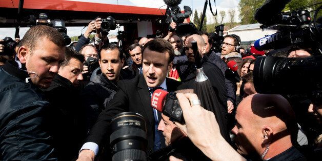 Emmanuel Macron, French presidential candidate, center, stands surrounded by journalists outside the Whirlpool Corp. plant in Amiens, France, on Wednesday, April 26, 2017. Macron returns to the campaign trail Wednesday after widespread criticism that a victory dinner he offered his team Sunday was premature and inappropriate given the deep divisions in the country. Photographer: Christophe Morin/Bloomberg via Getty Images