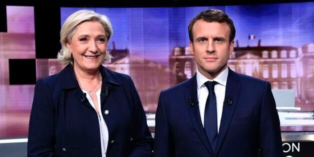 French presidential election candidate for the far-right Front National (FN) party, Marine Le Pen (L) and French presidential election candidate for the En Marche ! movement, Emmanuel Macron pose prior to the start of a live brodcast face-to-face televised debate in television studios of French public national television channel France 2, and French private channel TF1 in La Plaine-Saint-Denis, north of Paris, on May 3, 2017 as part of the second round election campaign.Pro-EU centrist Emmanuel Macron and far-right leader Marine Le Pen face off in a final televised debate on May 3 that will showcase their starkly different visions of France's future ahead of this weekend's presidential election run-off. / AFP PHOTO / POOL / Eric FEFERBERG / ALTERNATIVE CROP (Photo credit should read ERIC FEFERBERG/AFP/Getty Images)
