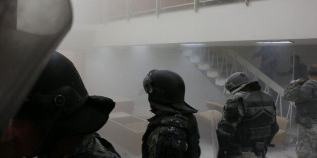 SKOPJE, MACEDONIA - APRIL 27: Police use tear gas to the protesters demonstrate inside the parliament as a session held to vote electing a parliament speaker canceled due to ongoing tension following a brawl between MPs at Macedonian Parliament in Skopje, Macedonia on April 27, 2017. People those entered the parliament from outside intervene in the MPs. (Photo by Besar Ademi/Anadolu Agency/Getty Images)