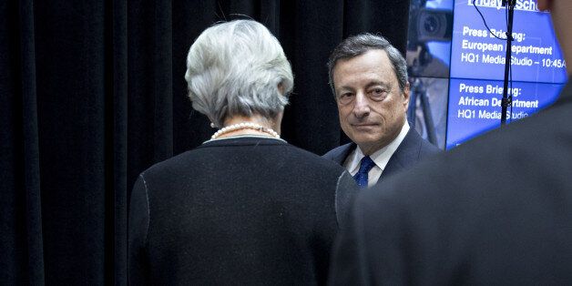 Mario Draghi, president of the European Central Bank (ECB), center, stands next to Christine Lagarde, managing director of the International Monetary Fund (IMF), after participating in a Group of 20 (G-20) finance ministers and central bank governors group photo on the sidelines of the spring meetings of the IMF and World Bank in Washington, D.C., U.S., on Friday, April 21, 2017. The emergence of protectionist forces could undermine a modest brightening of the global growth outlook and is putting severe strain on the post-World War II economic order, the IMF said this week. Photographer: Andrew Harrer/Bloomberg via Getty Images