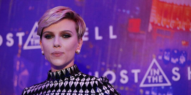 Actress Scarlett Johansson poses as she arrives at a premiere of the film