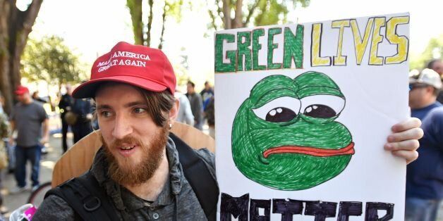 Andrew Knight holds a sign of Pepe the frog, a conservative icon, during a rally in Berkeley, California on April 27, 2017. Conservative firebrand Ann Coulter on April 26, 2017 canceled a planned appearance at the University of California, Berkeley, saying she had lost the backing of the groups that had sponsored her talk. The right-wing commentator had insisted she would show up at Berkeley, a famously progressive campus, on Thursday even though the university said it could not provide a suitable venue because of security threats. But Coulter said she was forced to reconsider her decision after the conservative Young America's Foundation and the Berkeley College Republicans, which had sponsored her talk, backed out, accusing the university of creating a 'hostile atmosphere.' / AFP PHOTO / Josh Edelson (Photo credit should read JOSH EDELSON/AFP/Getty Images)