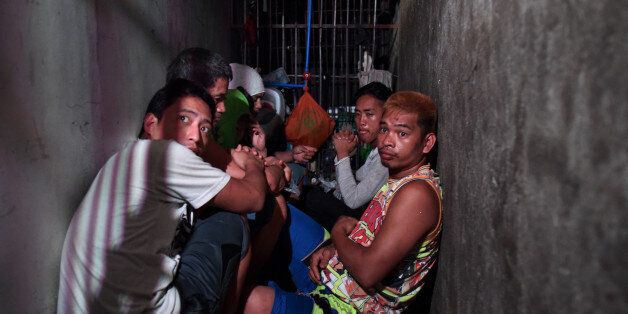 MANILA, PHILIPPINES - APRIL 27: Alleged drug suspects detained at a small secret cell behind a wooden cabinet on April 27, 2017 in Manila, Philippines. The commission on Human Rights raided a Manila police station on Thursday to uncover a space of about 3 by 15 feet, where dozens of drug suspects, including 3 women, were detained for a week and allegedly brought out to be beaten or tortured, according to reports. The detainees alleges that they were kept inside the cramped cell without window, ventilation or lights for days, without filing any case against them, while waiting until a relative comes up with at least a thousand dollars paid to the police in exchange for their release. (Photo by Jes Aznar/Getty Images)