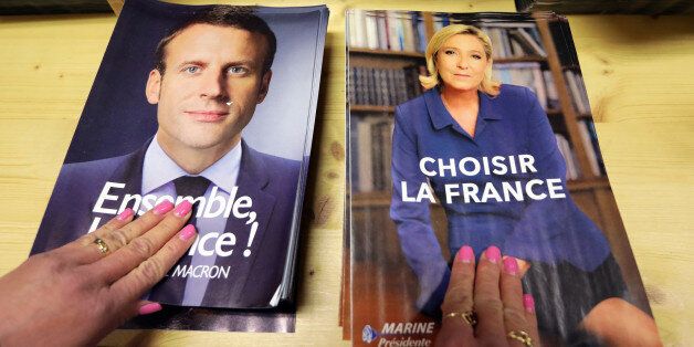 Civil servants prepare electoral documents for the upcoming second round of 2017 French presidential election as registered voters will receive an envelope containing the declarations of faith of each candidate, Emmanuel Macron (R) and Marine Le Pen along with the two ballot papers for the May 7 second round of the French presidential election, in Nice, France, May 3, 2017. REUTERS/Eric Gaillard