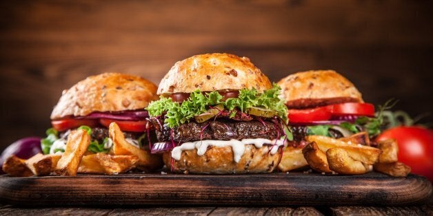 Delicious hamburgers on wooden background