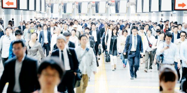A busy pedestrian walkway, businessmen and women, Tokyo. Daytime, interior, horizontal composition. Business, travel background.