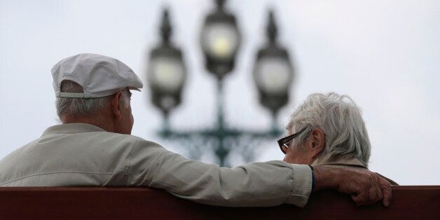 A retired couple sits on a bench in Enghien-les-Bains, north of Paris, August 26, 2013. France's government, which has been meeting with labour union heads about retirement issues, neared a deal with trade unions on Monday to overhaul the pension system via a slight lengthening of working lives, union chiefs said, as Europe's number two economy sought to bring a spiralling deficit under control. REUTERS/Christian Hartmann (FRANCE - Tags: POLITICS BUSINESS EMPLOYMENT)