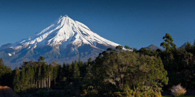 A late afternoon view of Mount Taranaki (Mt Egmont) from Lake Mangamahoe. Mt Taranaki is a stratovolcano that is active, but in a resting (quiescent) state.