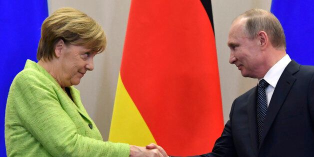 Russian President Vladimir Putin shakes hands with German Chancellor Angela Merkel after a press conference following their meeting at the Bocharov Ruchei state residence in Sochi on May 2, 2017. / AFP PHOTO / Alexander NEMENOV (Photo credit should read ALEXANDER NEMENOV/AFP/Getty Images)
