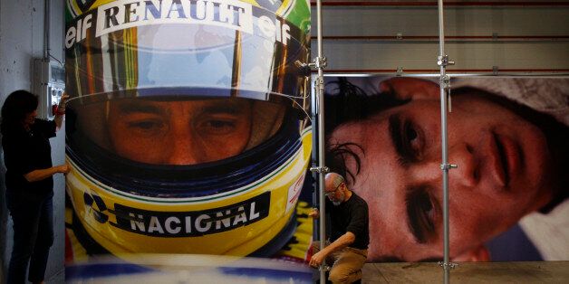 Architects set pictures of Brazilian Formula One driver Ayrton Senna for an exhibition at the Imola race track, northern Italy April 30, 2014. A mass was held at Imola Grand Prix in memory of Formula 1 drivers Ayrton Senna and Roland Ratzenberger to mark the 20th anniversary of their deaths. REUTERS/Alessandro Garofalo (ITALY - Tags: SPORT MOTORSPORT F1 ANNIVERSARY)
