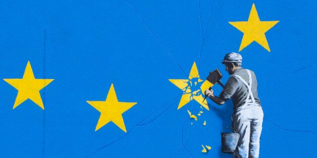 Graffiti artist Banksy has unveiled his latest piece about Brexit in Dover, United Kingdom. The artwork shows a man up a ladder chipping a gold star away from the EU flag. The piece appears on the wall of a derelict building directly adjacent to the A20 road less than half a mile to the ferry terminal of Dover. (photo by Andrew Aitchison / In pictures via Getty Images)