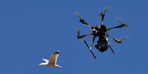 A seagull flies past a drone equipped with a thermal camera used by Carabinieri to securize the area during the meeting of Foreign Affairs Ministers from the Group of Seven (G7) industrialised countries, on April 11, 2017 in Lucca, Tuscany. / AFP PHOTO / Vincenzo PINTO (Photo credit should read VINCENZO PINTO/AFP/Getty Images)
