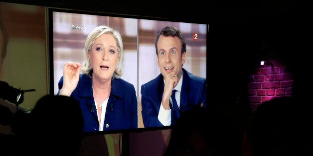 PARIS, FRANCE - MAY 03: Supporters of President of the political movement 'En Marche !' ( Onwards !) and French presidential election candidate Emmanuel Macron watch the TV debate between Emmanuel Macron and Marine Le Pen on a huge screen on May 03, 2017 in Paris, France. Macron and Le Pen arrived in the lead positions in the first round of the French presidential elections. France will hold the second round on May 07, 2017. (Photo by Chesnot/Getty Images)
