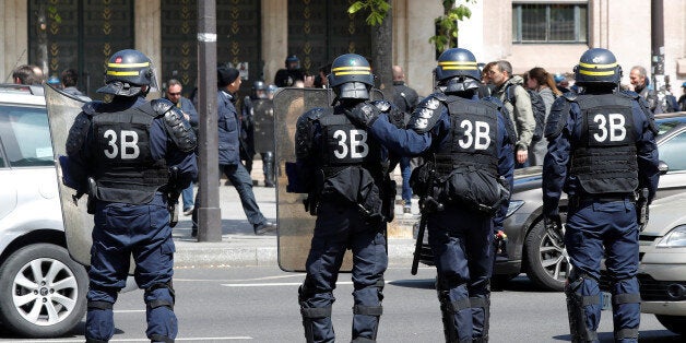 French CRS riot police secure the area in front of the Lycee Helene Boucher during a demonstration by high school students to protest the results of the first round of the presidential election in Paris, France, April 27, 2017. REUTERS/Charles Platiau