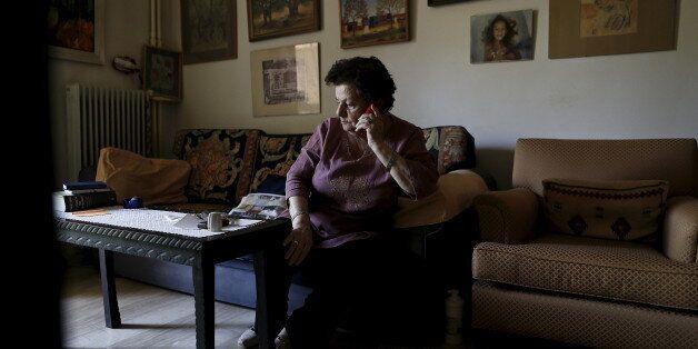 Pensioner Zina Razi, 79, talks on the phone at her house in Athens May 6, 2015. The plight of 79-year-old Athenian Zina Razi and thousands like her strikes at the heart of why talks between Greece and its creditors have collapsed. She lives off a pension system that helps to consume a huge proportion of state spending and can appear overly indulgent - but still she's broke. Picture taken May 6, 2015. REUTERS/Alkis Konstantinidis