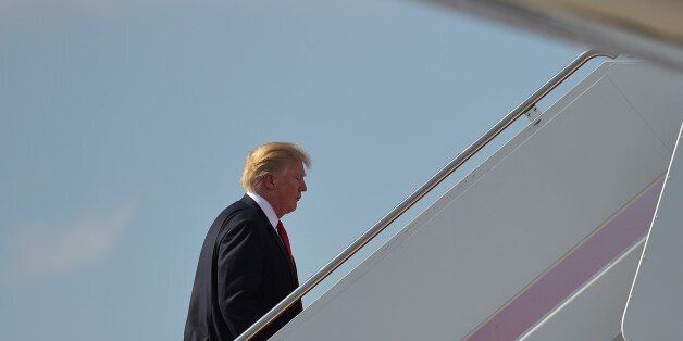 US President Donald Trump boards Air Force One before departing from Palm Beach International Airport in West Palm Beach, Florida on March 19, 2017. Trump is returning to Washington after spending the weekend at his Mar-a-Lago estate. / AFP PHOTO / MANDEL NGAN (Photo credit should read MANDEL NGAN/AFP/Getty Images)